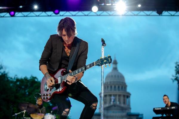 Keith Urban performing onstage with a guitar at the 2023 CMT Music Awards in Austin, Texas