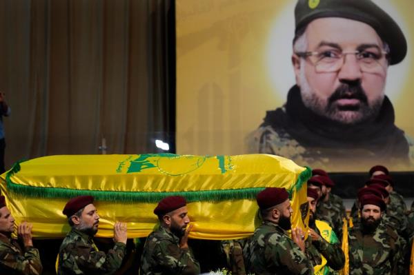 Hezbollah fighters carry the coffin of their top commander Fouad Shukur who was killed in an Israeli airstrike on July 30, 2024