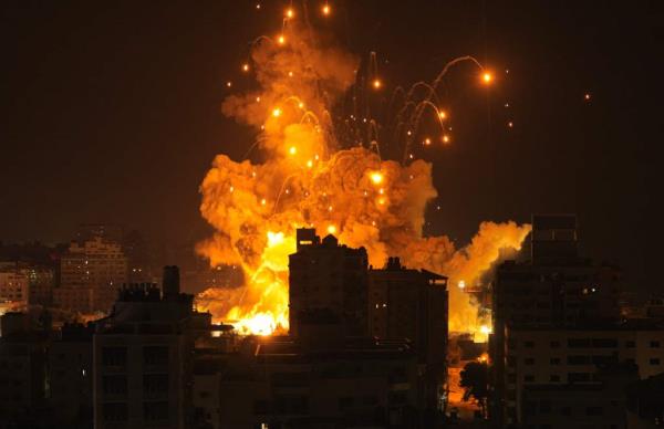 A missile explodes in Gaza City during an Israeli air strike on October 8, 2023.